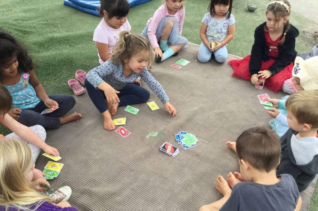 Kids outside playing Uno at Childhood Centre