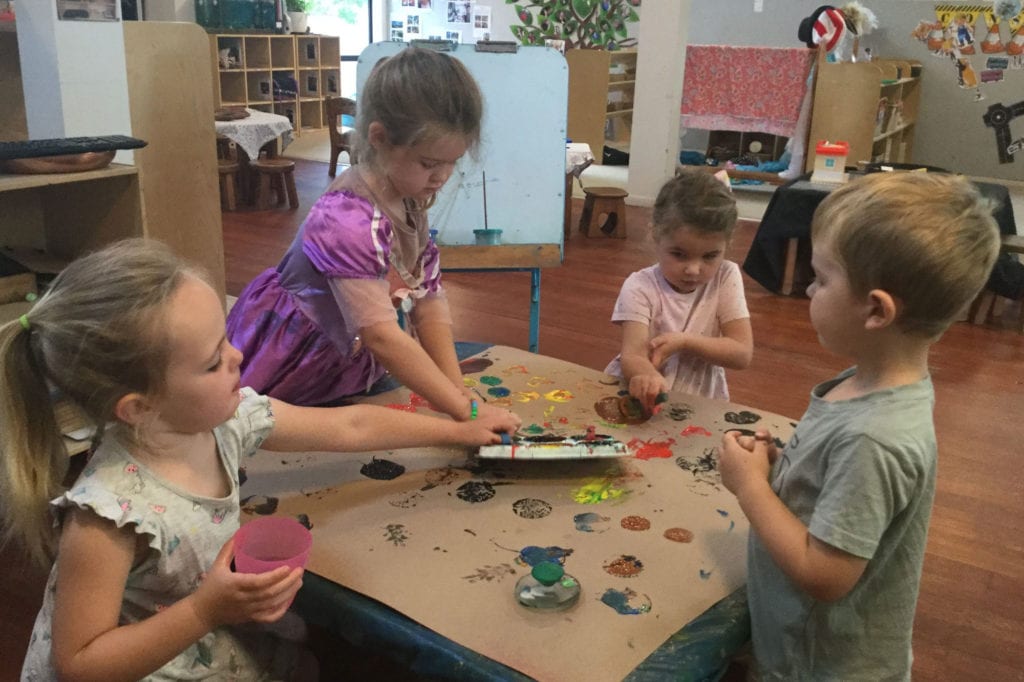 Young children playing with paints at Childhood Centre Hamilton